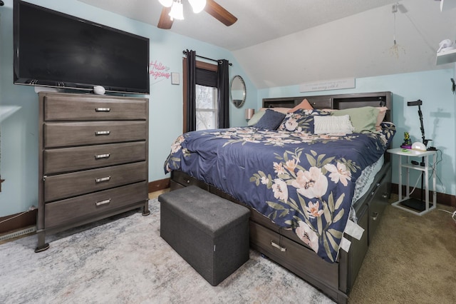 carpeted bedroom featuring a ceiling fan, baseboards, and vaulted ceiling