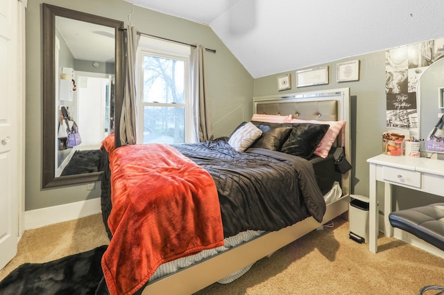 carpeted bedroom featuring lofted ceiling