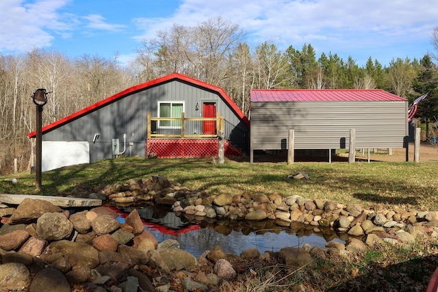 N8690 Island Lake Rd, Casey, WI 54801 - rear view of property featuring a garden pond and a yard