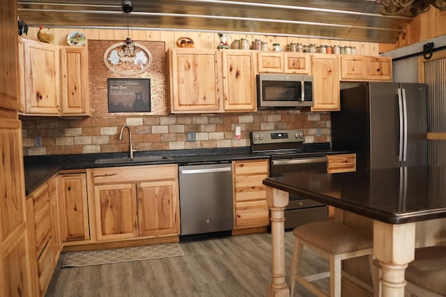 N8690 Island Lake Rd, Casey, WI 54801 - kitchen featuring a sink, light brown cabinets, dark countertops, and stainless steel appliances