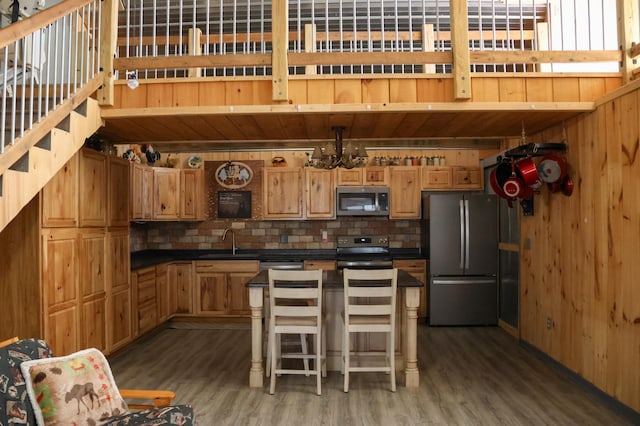 N8690 Island Lake Rd, Casey, WI 54801 - kitchen with a sink, appliances with stainless steel finishes, decorative backsplash, and light wood-type flooring