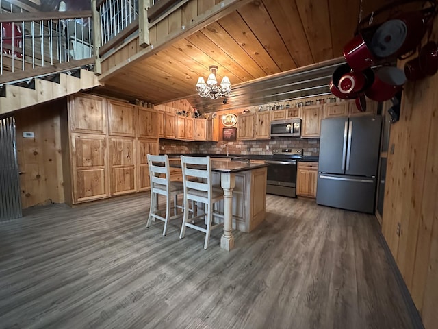 N8690 Island Lake Rd, Casey, WI 54801 - kitchen with dark countertops, an inviting chandelier, a sink, stainless steel appliances, and wood finished floors