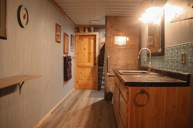 N8690 Island Lake Rd, Casey, WI 54801 - bathroom featuring vanity, toilet, wood finished floors, and tasteful backsplash