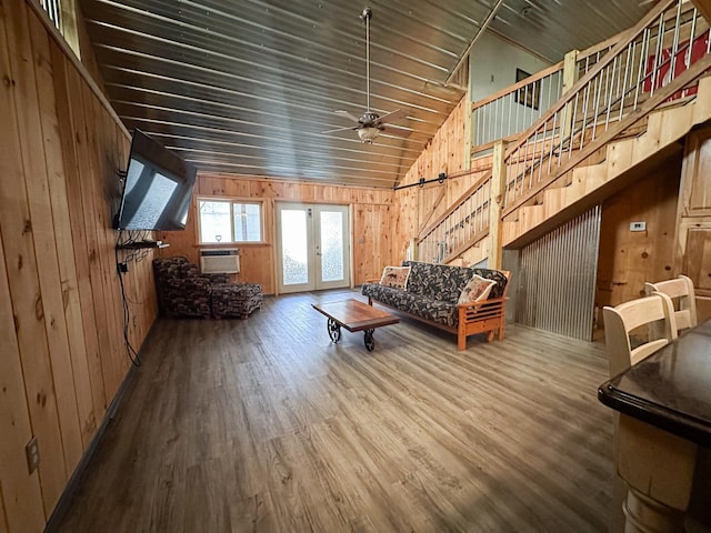 N8690 Island Lake Rd, Casey, WI 54801 - living room with wood walls, wood finished floors, ceiling fan, french doors, and vaulted ceiling