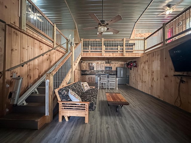 N8690 Island Lake Rd, Casey, WI 54801 - living room with dark wood-type flooring, wood walls, and ceiling fan