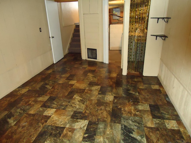 finished below grade area featuring stairway and visible vents