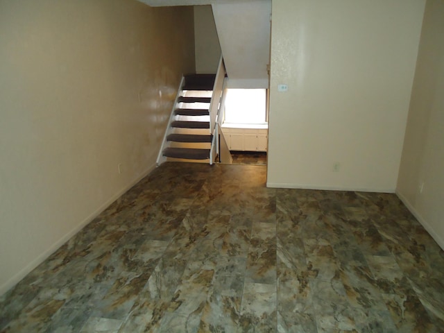 interior space with stairway and baseboards
