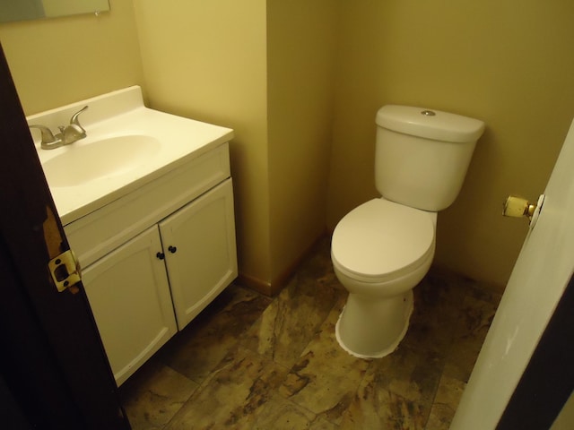 bathroom featuring toilet and vanity