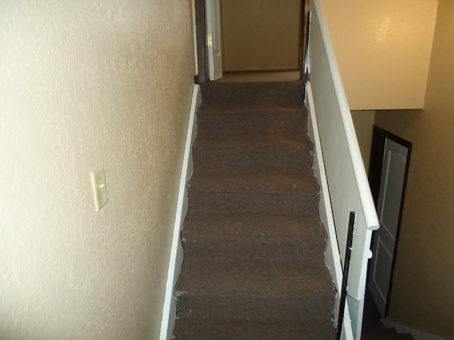 stairway with a textured wall