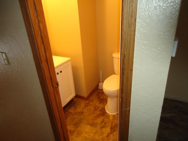 bathroom with toilet and vanity