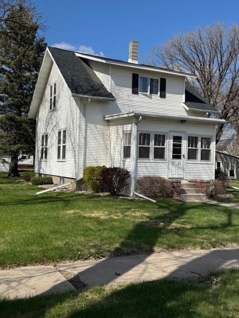 1120 12th Ave, Clarkfield, MN 56223 - view of front of property featuring a chimney and a front lawn