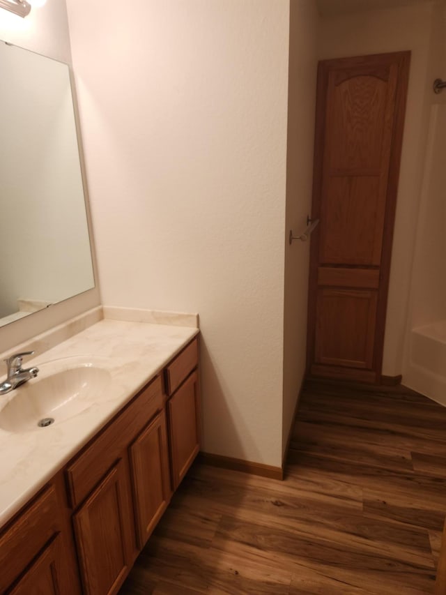 2155 6th Ln SE Unit 212, Cambridge, MN 55008 - bathroom with vanity and wood finished floors