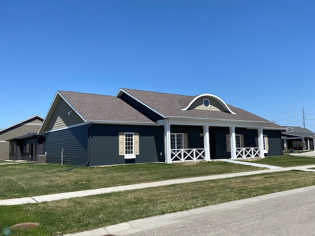 4891 Foxtail Ln S, Fargo, ND 58104 - view of front facade with a front yard, a shingled roof, and central air condition unit