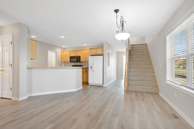 1501 Praha St SE, New Prague, MN 56071 - kitchen with light wood-style flooring, black microwave, white fridge with ice dispenser, and recessed lighting
