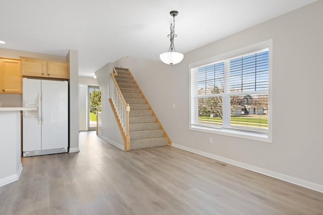 1501 Praha St SE, New Prague, MN 56071 - interior space featuring light wood finished floors, stairway, baseboards, and visible vents