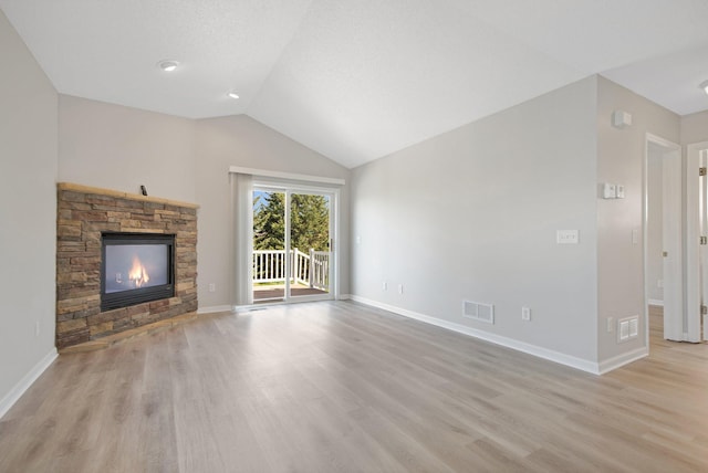 1501 Praha St SE, New Prague, MN 56071 - unfurnished living room with visible vents, light wood-style flooring, and a stone fireplace