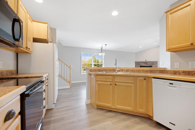 1501 Praha St SE, New Prague, MN 56071 - kitchen with light wood finished floors, light brown cabinetry, a sink, dishwasher, and black microwave