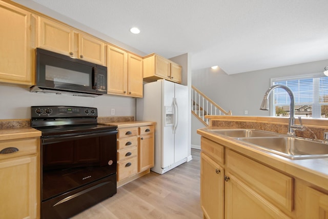 1501 Praha St SE, New Prague, MN 56071 - kitchen featuring light brown cabinetry, a sink, black appliances, light countertops, and light wood-type flooring