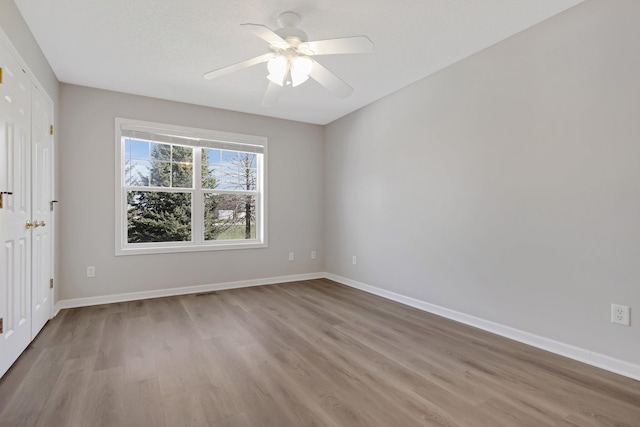 1501 Praha St SE, New Prague, MN 56071 - unfurnished bedroom with wood finished floors, baseboards, and ceiling fan
