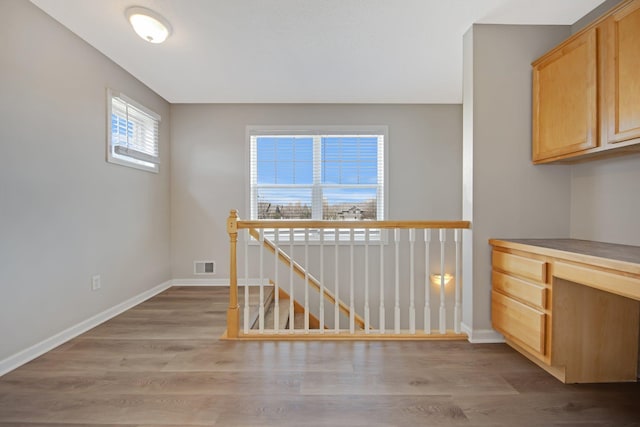 1501 Praha St SE, New Prague, MN 56071 - interior space with baseboards, visible vents, and wood finished floors