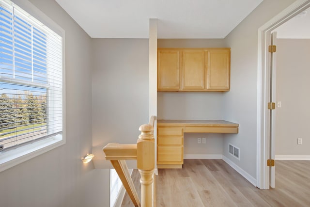 1501 Praha St SE, New Prague, MN 56071 - unfurnished office with built in study area, visible vents, baseboards, and light wood-type flooring