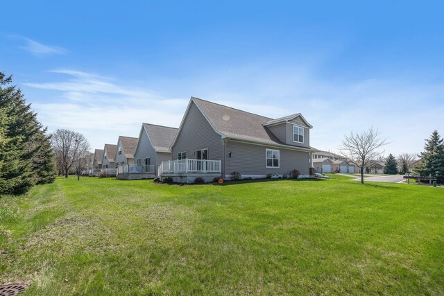 1501 Praha St SE, New Prague, MN 56071 - view of property exterior with a yard, roof with shingles, and a deck