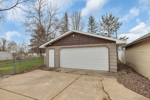 detached garage featuring fence