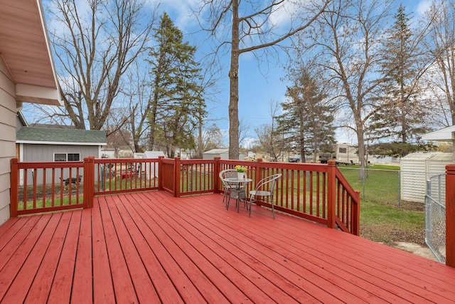 wooden deck featuring a fenced backyard and a lawn