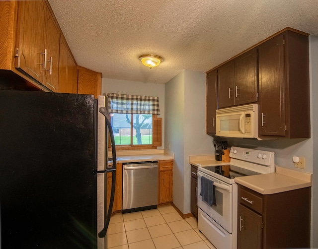 11342 Ibis St NW, Coon Rapids, MN 55433 - kitchen featuring appliances with stainless steel finishes, light countertops, a textured ceiling, and light tile patterned floors
