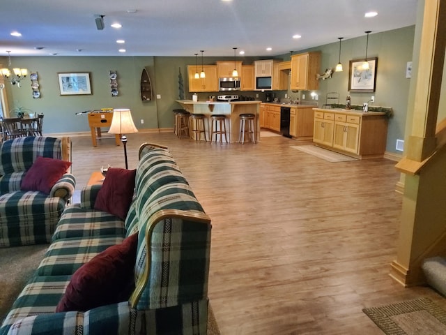 25124 Firefly Ave, Wyoming, MN 55092 - living area featuring baseboards, light wood-type flooring, a chandelier, and recessed lighting