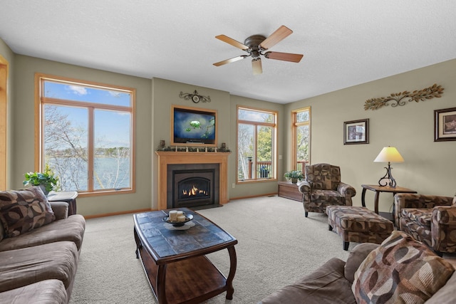 25124 Firefly Ave, Wyoming, MN 55092 - carpeted living room featuring a textured ceiling, a fireplace with flush hearth, a ceiling fan, and baseboards