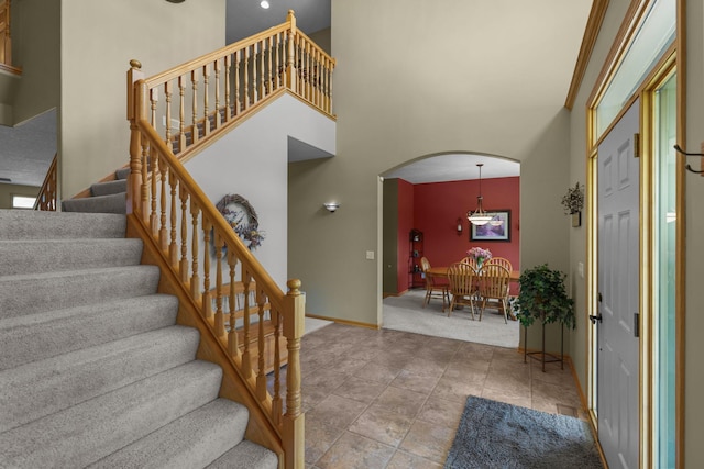 25124 Firefly Ave, Wyoming, MN 55092 - carpeted entrance foyer featuring arched walkways, a high ceiling, stairs, and baseboards