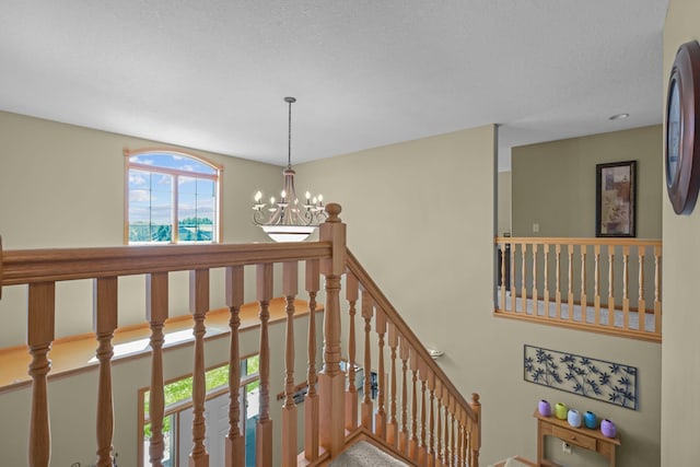 25124 Firefly Ave, Wyoming, MN 55092 - stairway with a chandelier and a textured ceiling
