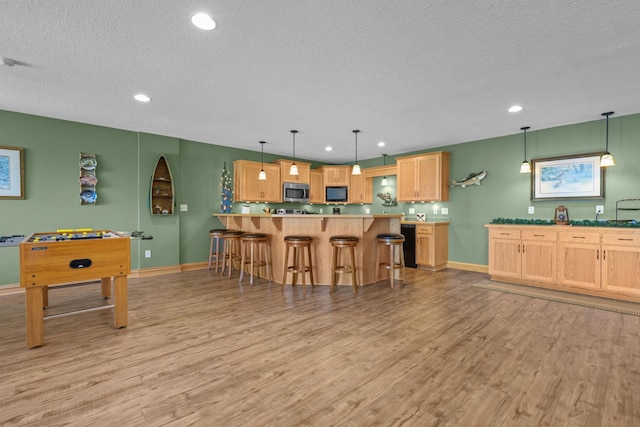 25124 Firefly Ave, Wyoming, MN 55092 - recreation room with a textured ceiling, light wood finished floors, baseboards, and recessed lighting