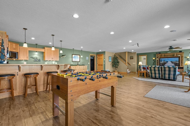25124 Firefly Ave, Wyoming, MN 55092 - recreation room featuring recessed lighting, a textured ceiling, light wood finished floors, and a ceiling fan