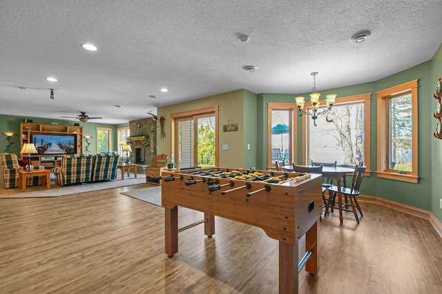 25124 Firefly Ave, Wyoming, MN 55092 - recreation room featuring a textured ceiling, wood finished floors, a chandelier, recessed lighting, and baseboards