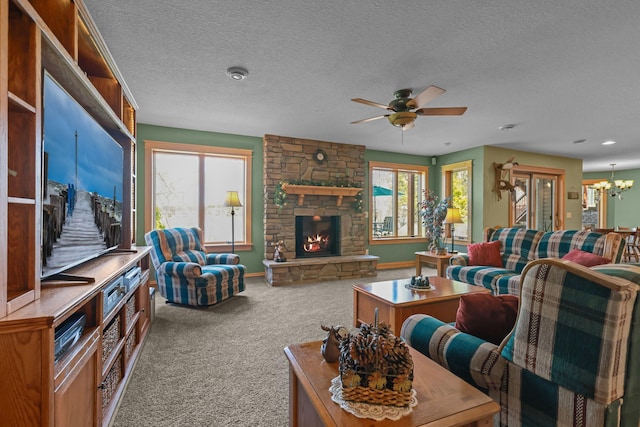 25124 Firefly Ave, Wyoming, MN 55092 - living room featuring carpet flooring, a stone fireplace, baseboards, a textured ceiling, and a ceiling fan