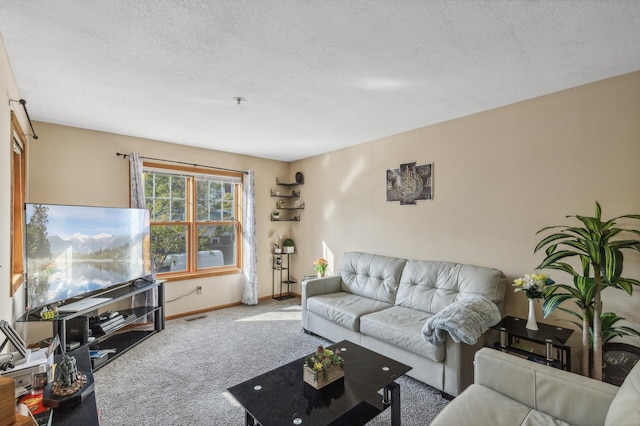 living area featuring baseboards, carpet flooring, a textured ceiling, and visible vents