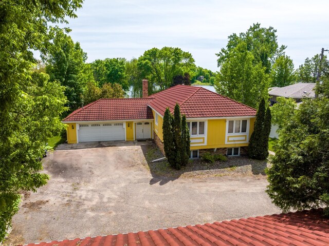 6365 Bay Ridge Rd, Mound, MN 55364 - view of front of property featuring a tile roof, a chimney, asphalt driveway, and an attached garage