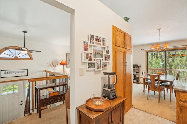 6637 Falstaff Rd, Woodbury, MN 55125 - corridor with light colored carpet, healthy amount of natural light, and a chandelier