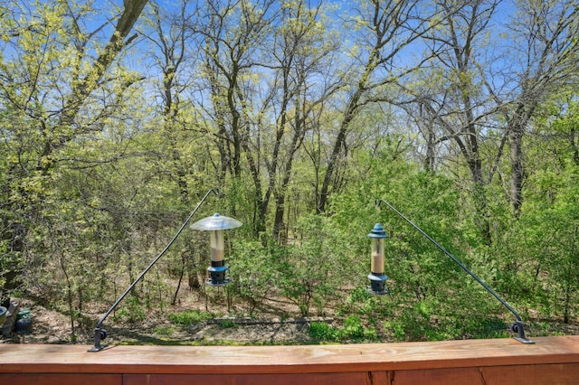 6637 Falstaff Rd, Woodbury, MN 55125 - view of yard with a wooded view and a deck