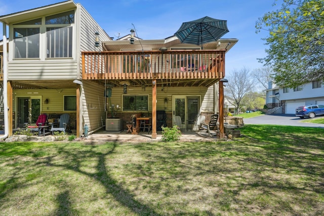 6637 Falstaff Rd, Woodbury, MN 55125 - back of house featuring a wooden deck, a yard, a patio, and central air condition unit