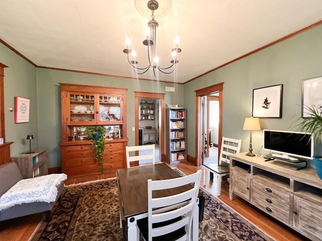 406 Pennsylvania Ave, Adrian, MN 56110 - dining room with wood finished floors, baseboards, ornamental molding, and a notable chandelier