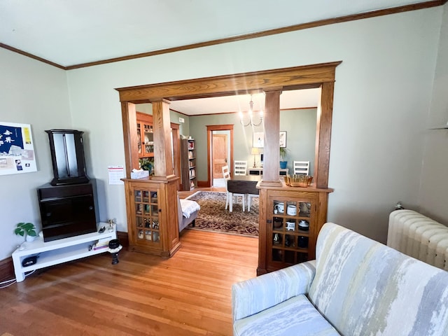 406 Pennsylvania Ave, Adrian, MN 56110 - living area featuring baseboards, ornamental molding, light wood finished floors, and a chandelier