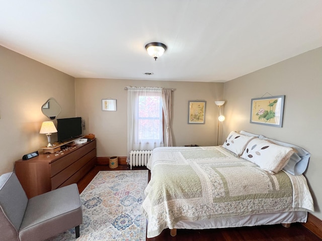 406 Pennsylvania Ave, Adrian, MN 56110 - bedroom featuring radiator, baseboards, and wood finished floors