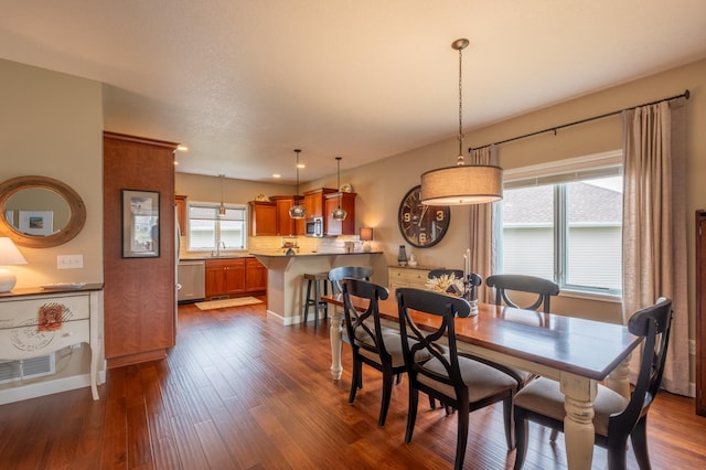 dining area featuring baseboards, dark wood-type flooring, and visible vents
