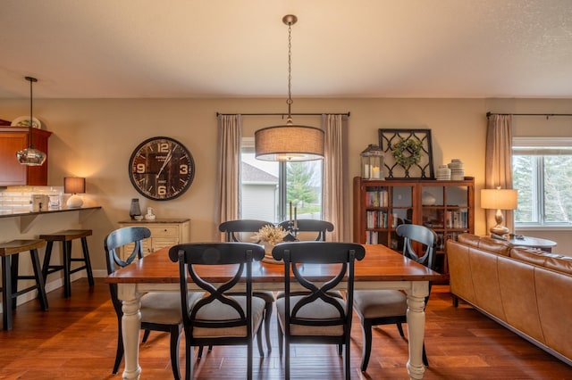dining area with dark wood-type flooring