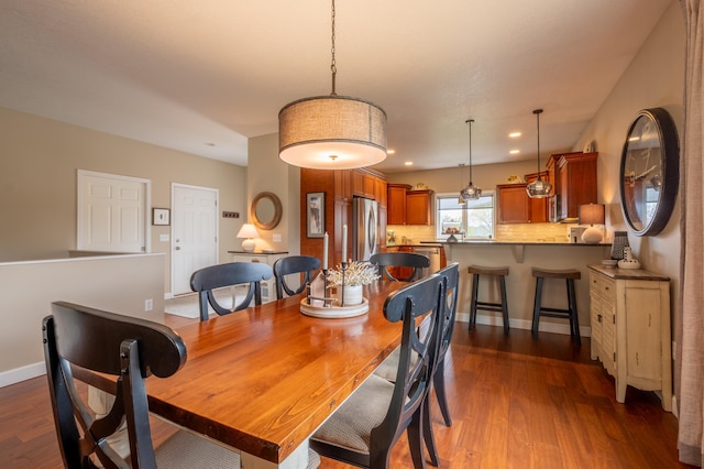 dining room featuring baseboards, dark wood-style floors, and recessed lighting