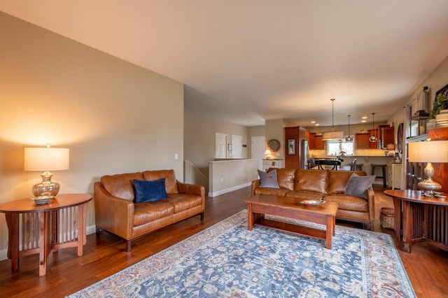 living room with baseboards and wood finished floors