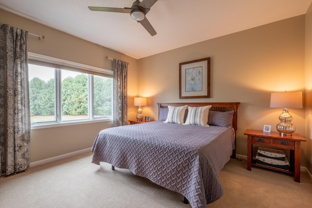 carpeted bedroom with baseboards and a ceiling fan